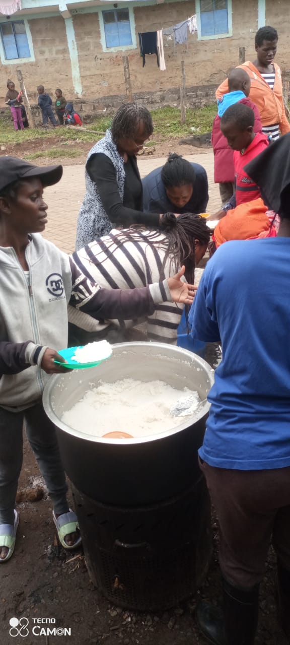 Community members serving food to children